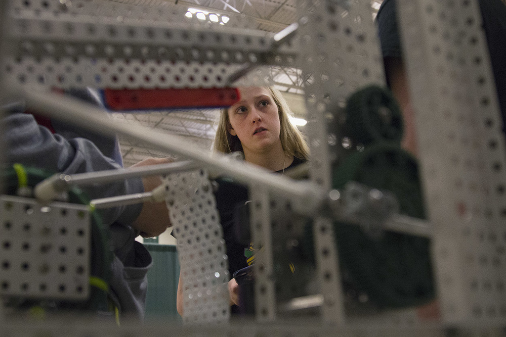  Kaitlyn De Kan, 17, talks with her teammates during the VEX Missouri State Robotics Championship in Rolla on Saturday. The team's robot sits on the table in front of them as they discuss strategy. 