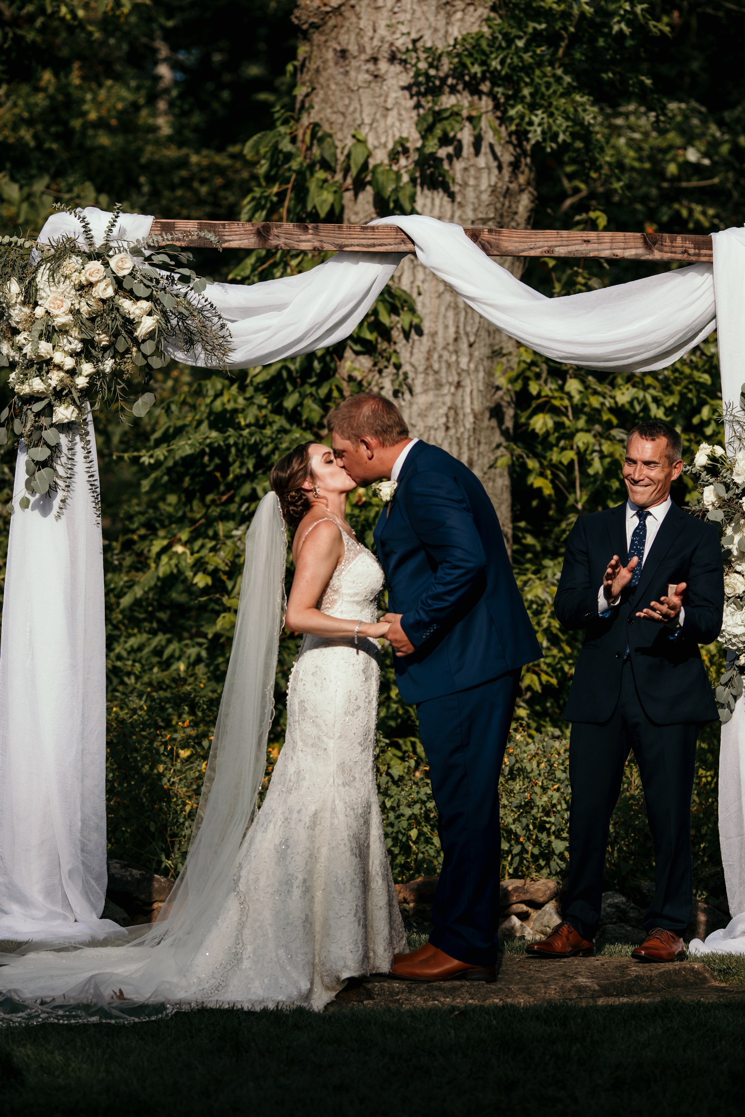 First kiss at the outdoor wedding ceremony and brandywine manor house.