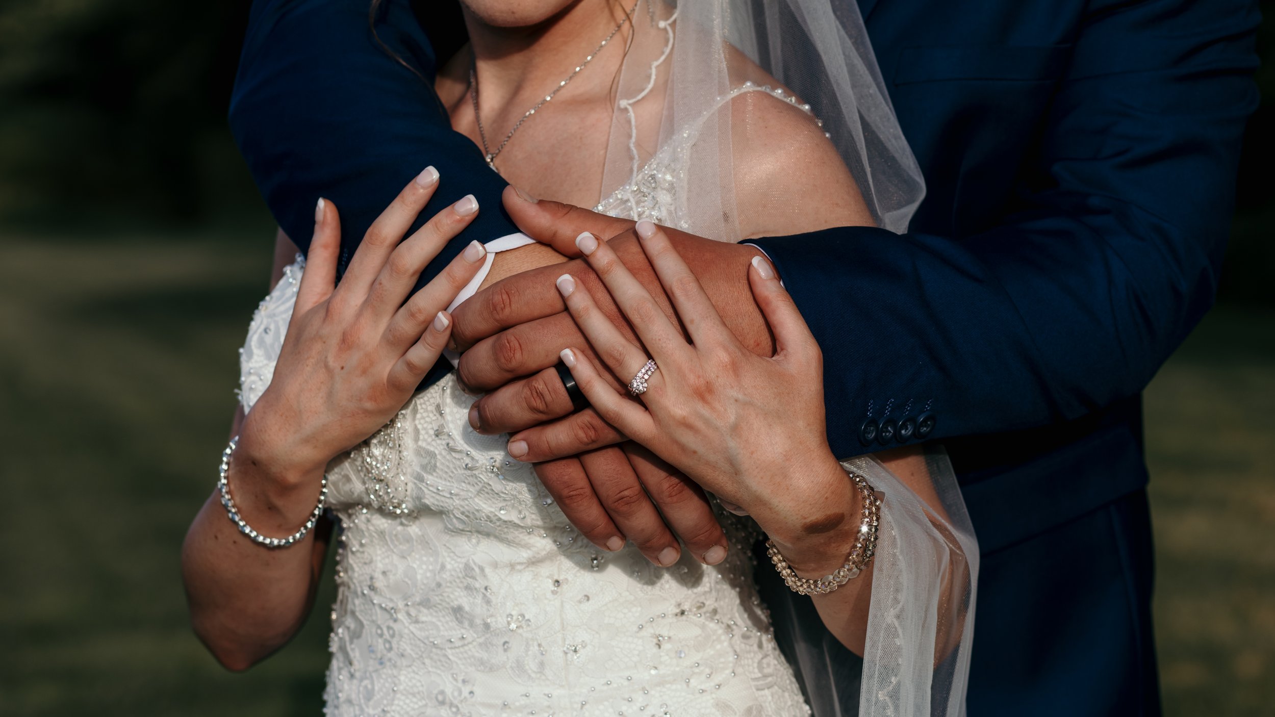 Close up of bride and grooms hands.