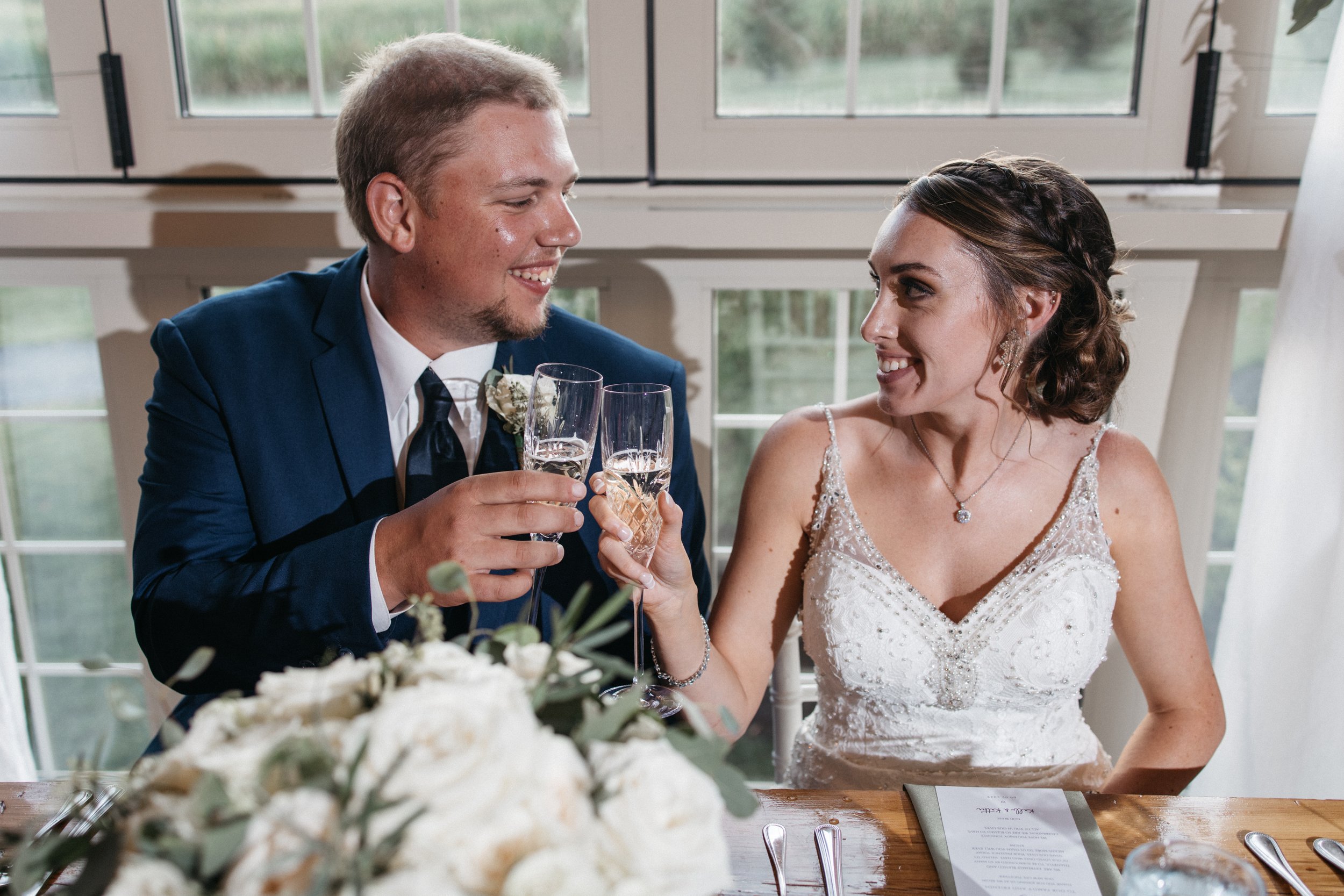 Bride and Groom clink glasses.