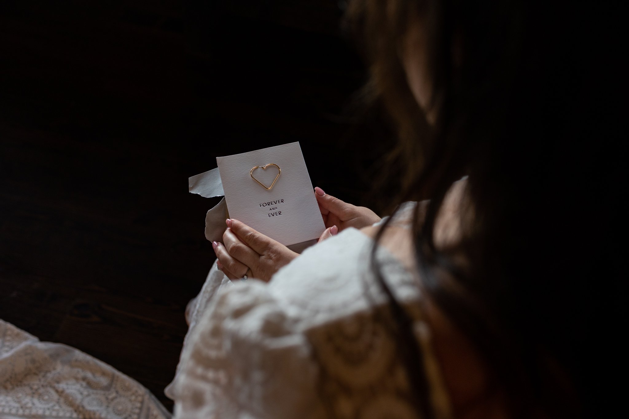 A bride holds a note from her husband.