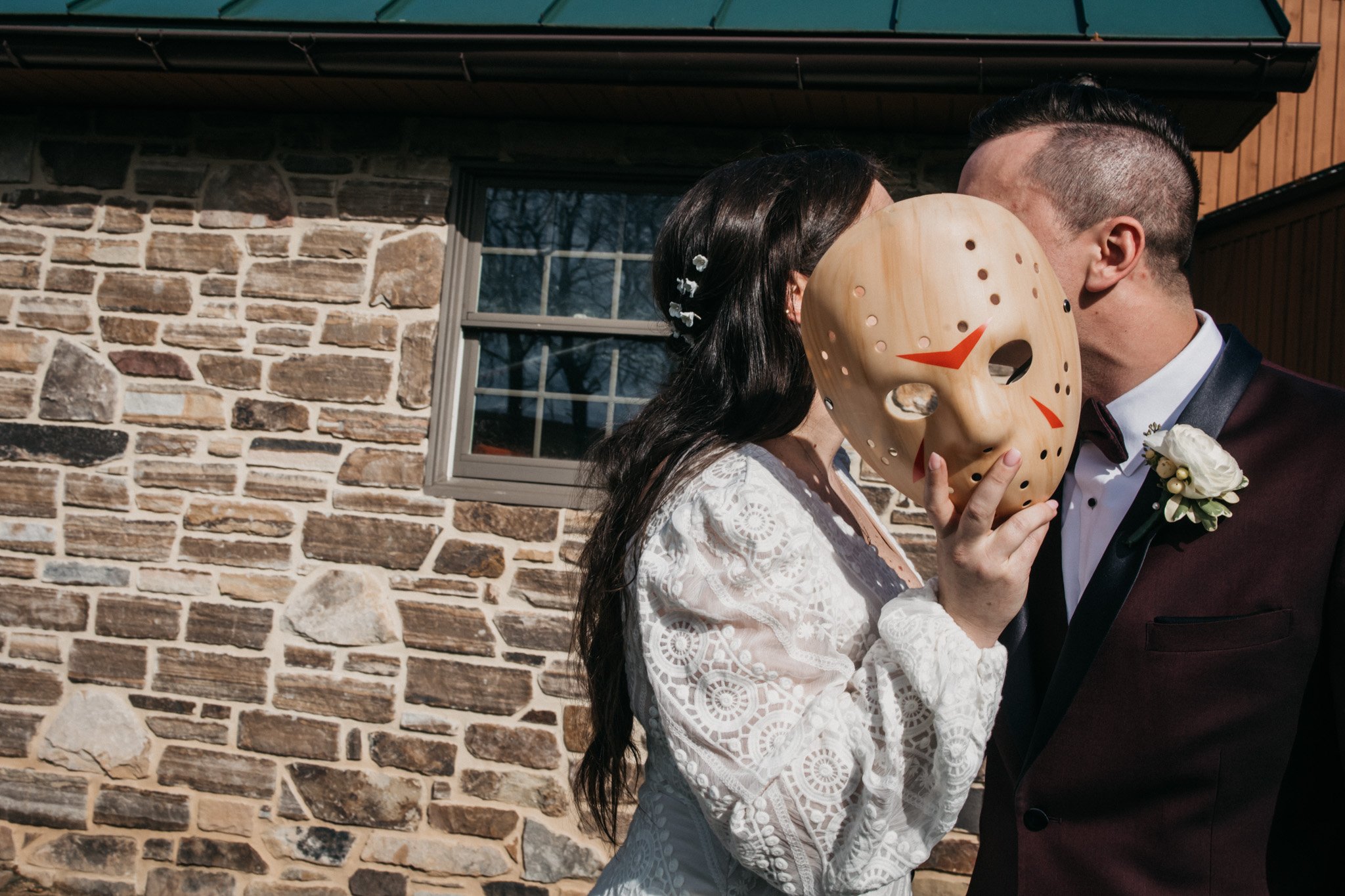 A bride surprises her husband with a halloween jason mask on their wedding day.