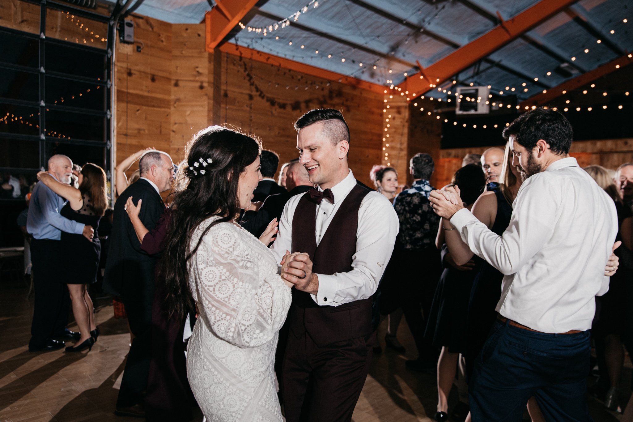 A bride and groom dancing at a wedding reception.