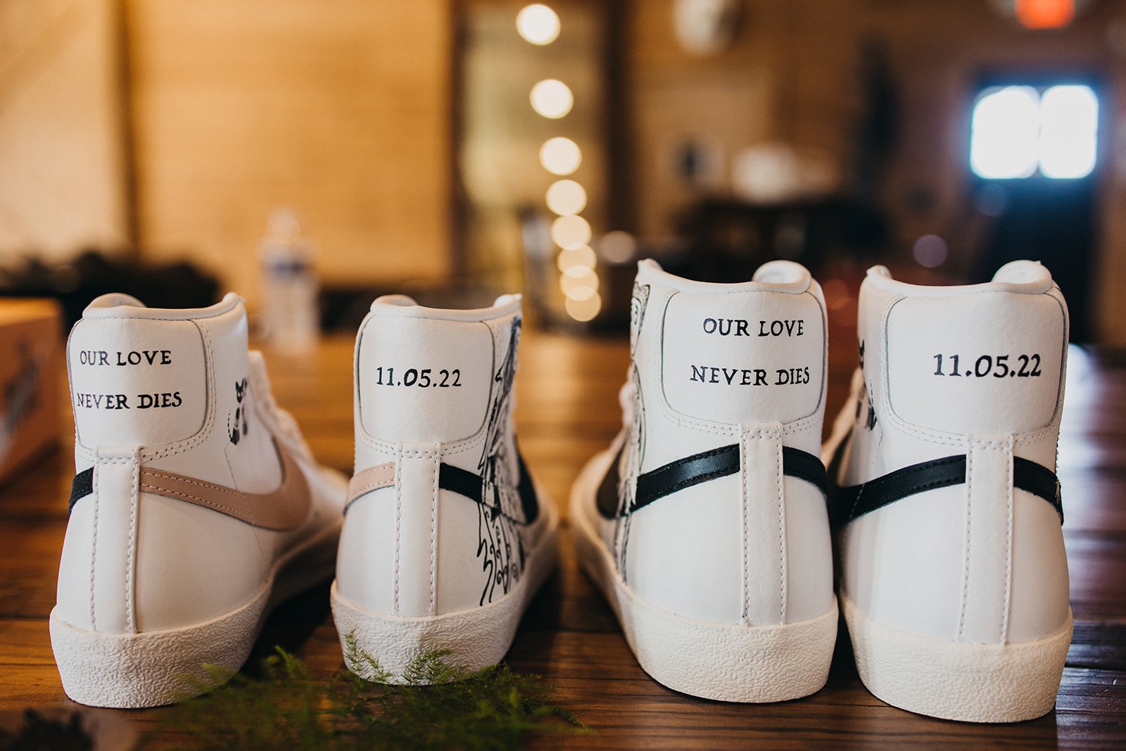 Two Nike shoes painted with Nightmare Before Christmas and a wedding date.