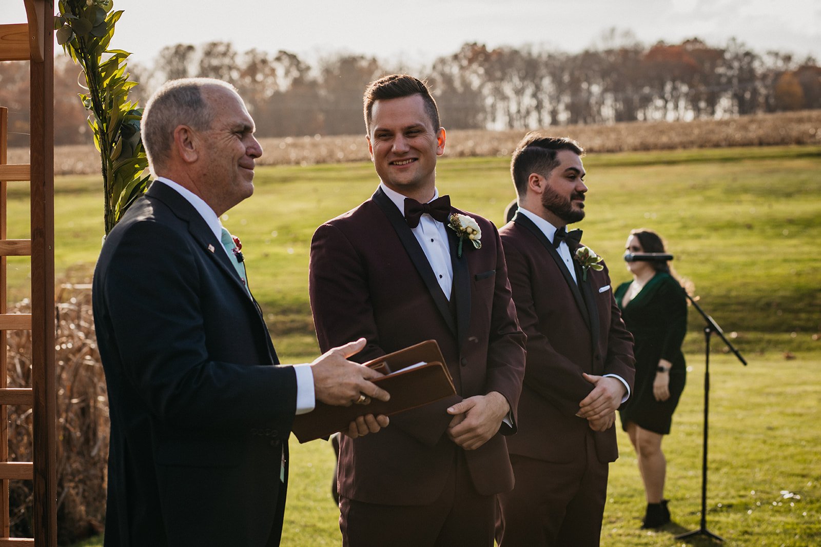 A groom smiles after seeing his wife at the wedding ceremony.