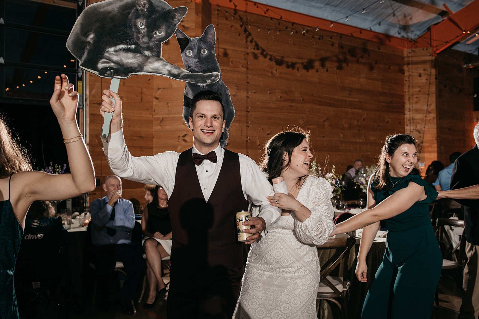 A groom with a cardboard cut out of his cat.