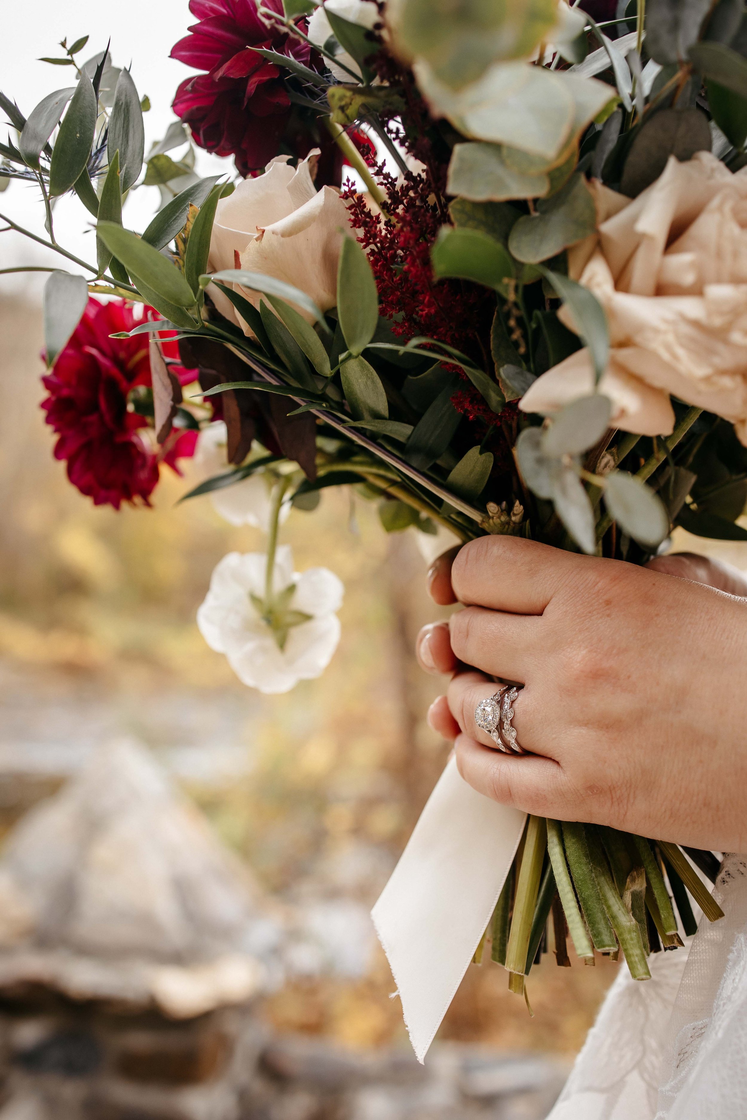 A close up of a bouquet and her wedding ring.
