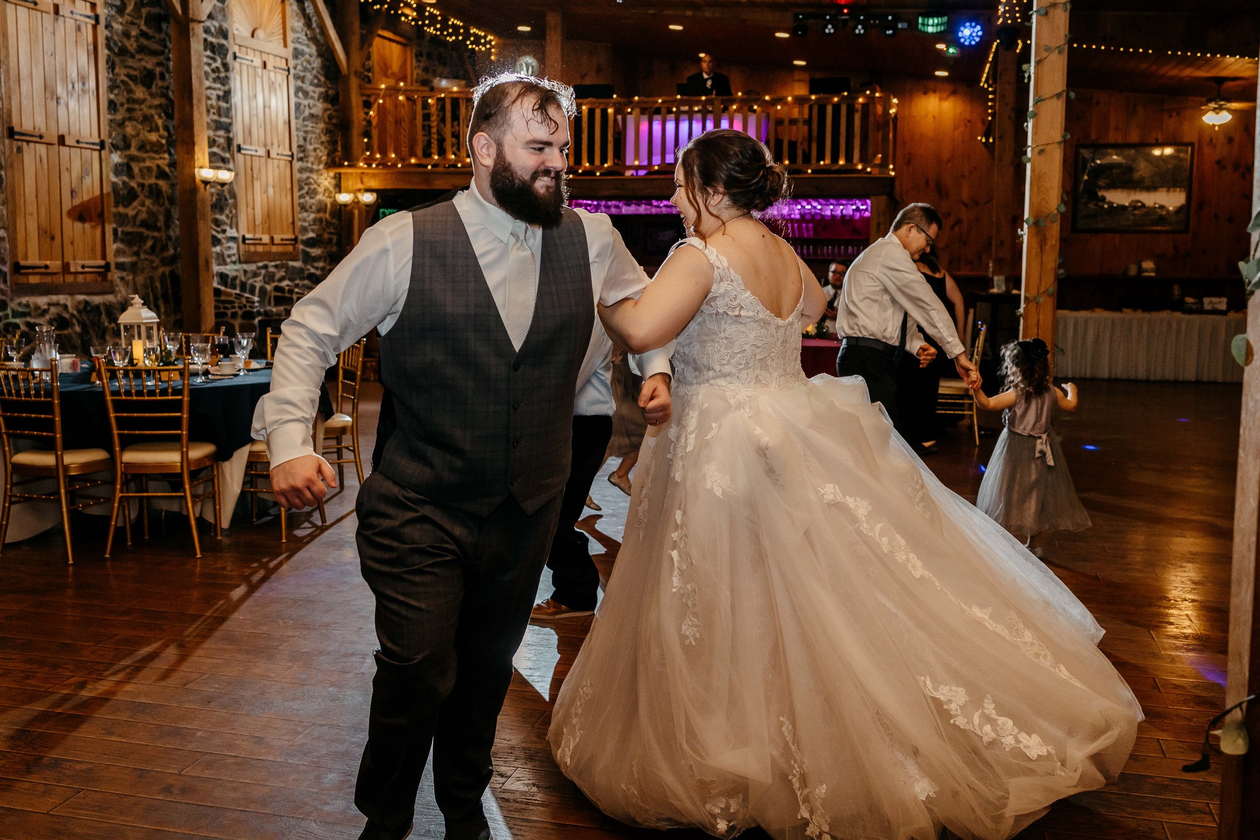 The bride and girl locked arms and dance in a circle together..