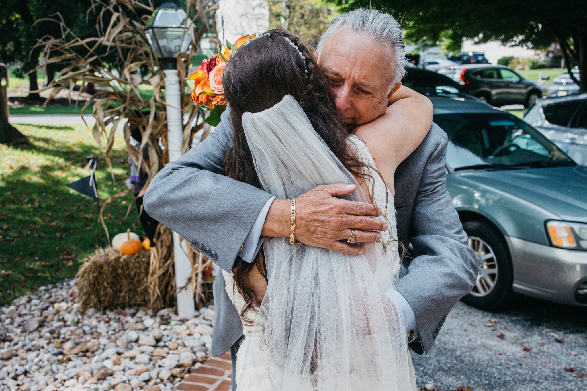 A bride hugs her dad.