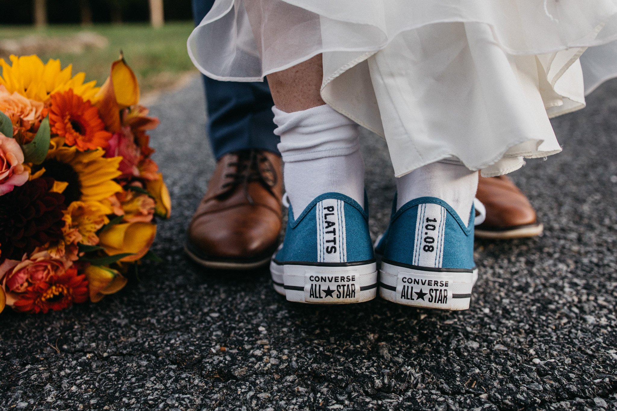 A bride wearing custom wedding day converse.