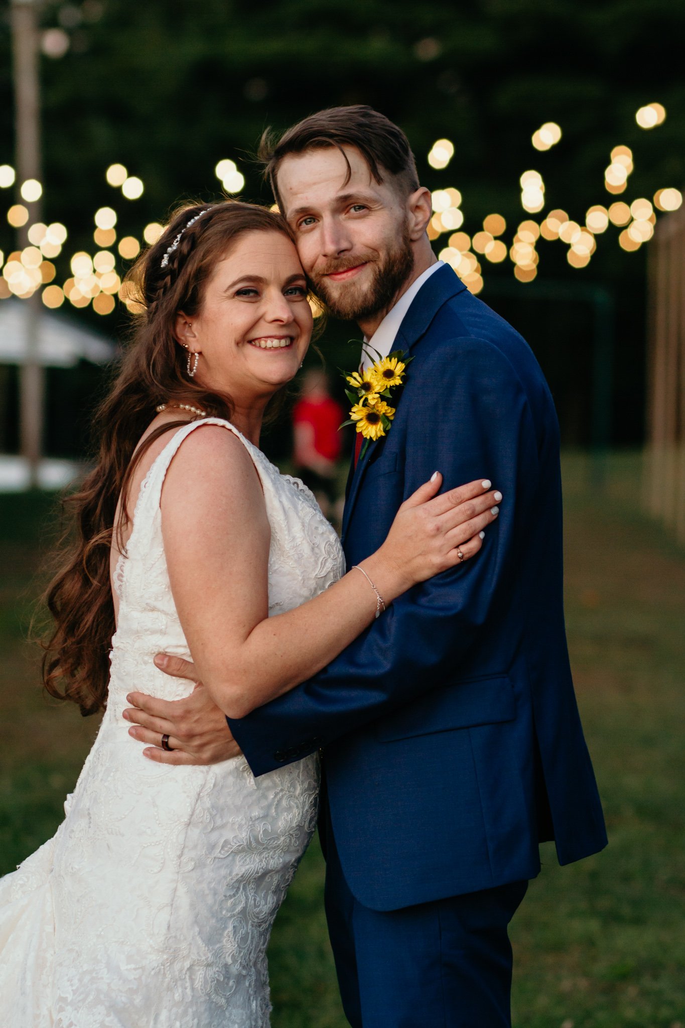 A bride and groom with twinkle lights.