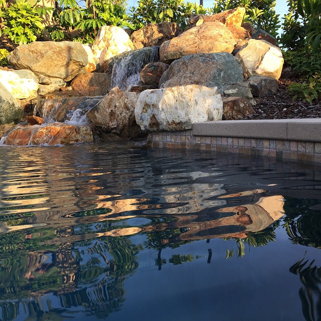 Natural rock waterfall set into pool.