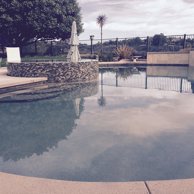 Pebble pool, cantilever coping, vanishing perimeter spa.