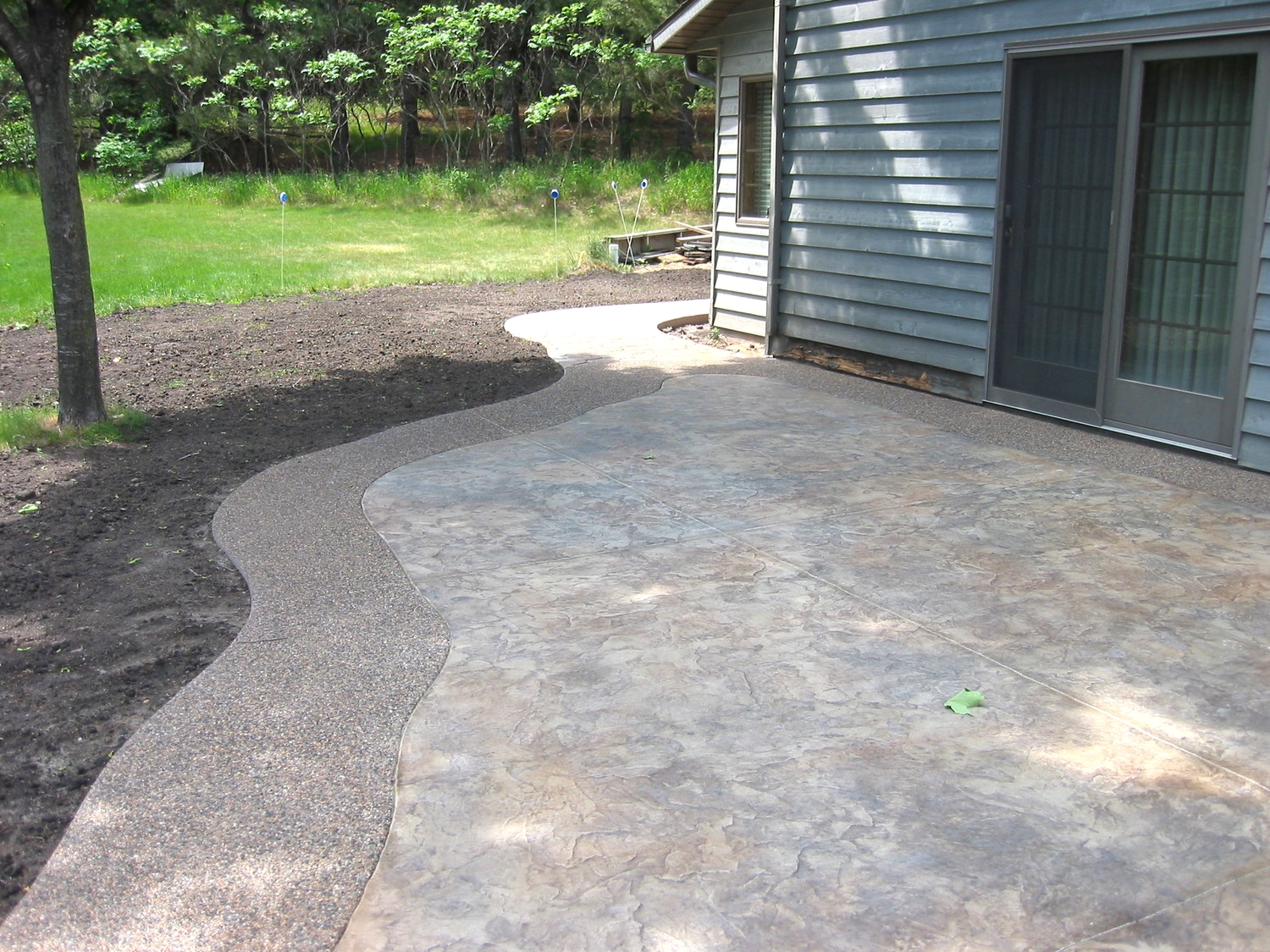 Stamped and Colored Concrete with an Exposed Aggregate Border