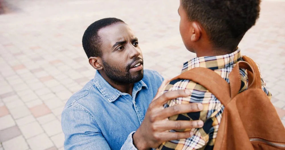 a father giving instructions to his son