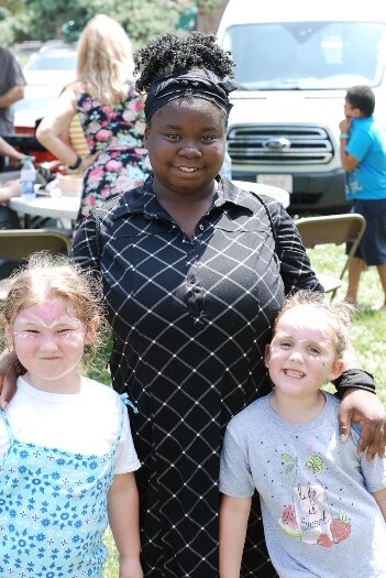 Smiles all around for these girls after getting their school supplies and books.
