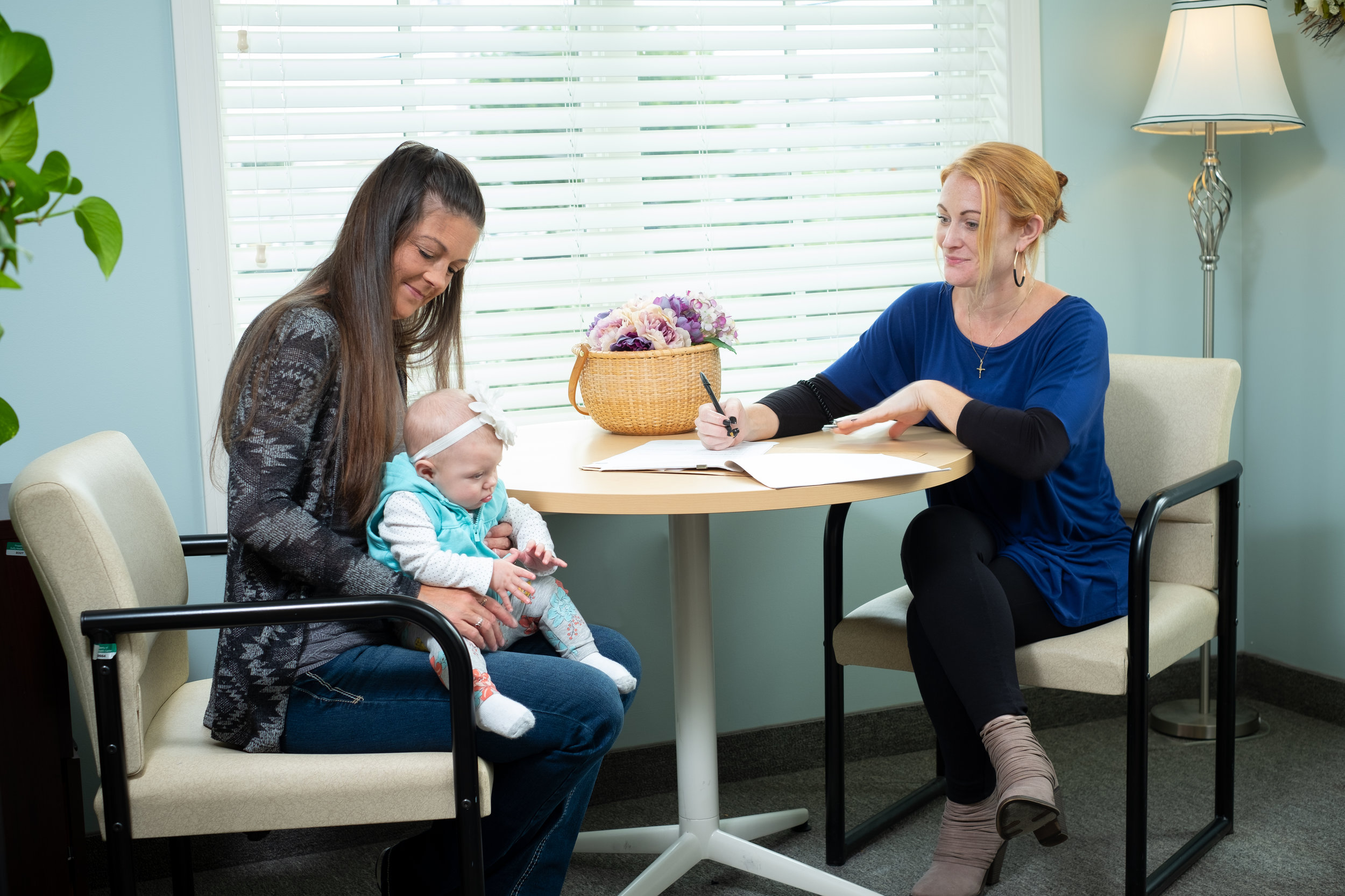 Sarah, la entrenadora de recuperación de pares, se reúne con una clienta y su bebé.