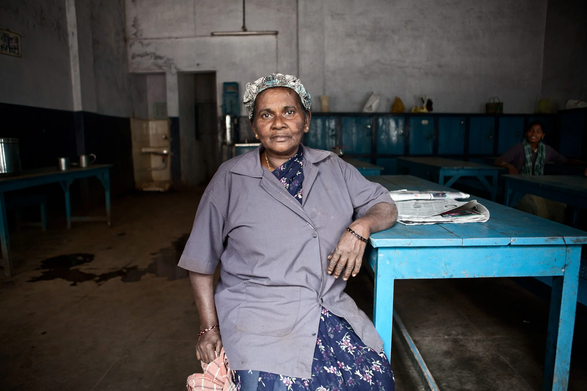 Leela, one of the older factory workers on the tea estate, sits in the "Labourer rest room" toward the end of the working day.