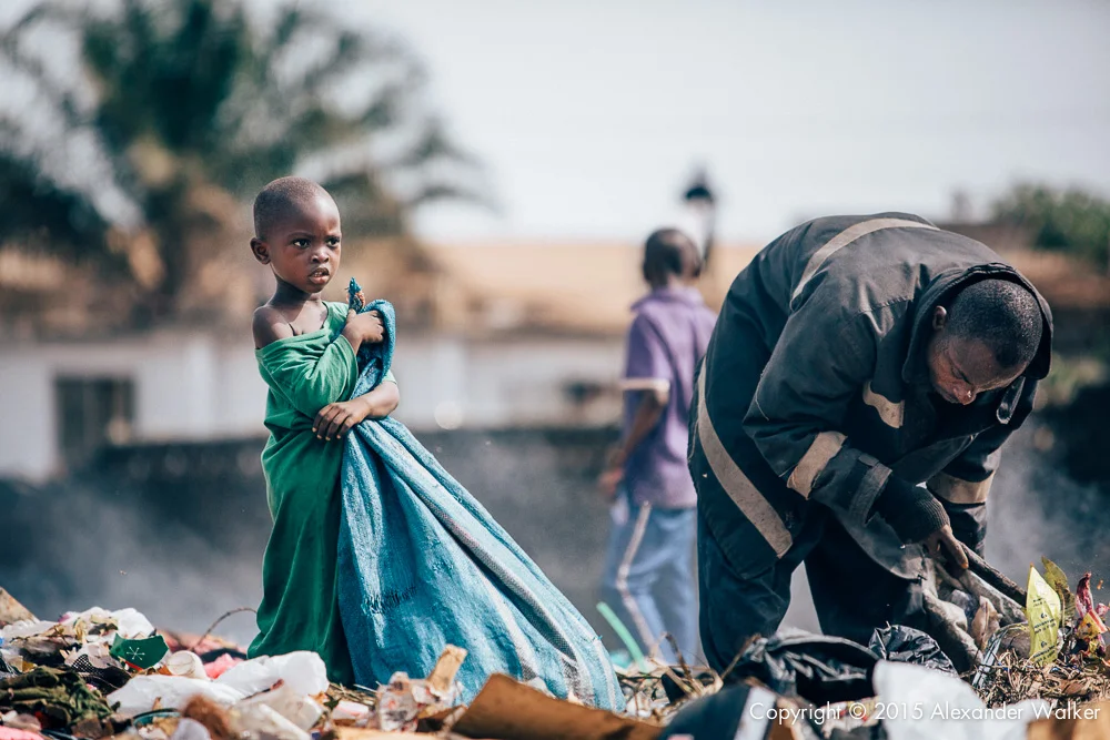 Osman (L) and his father Hassan (R) sort through rubbish on the rubbish dump in which they live. One of many in Freetown, Sierra Leone. They are looking for anything valuable which can either be recycled, or sold on. Comic Relief awarded Childhope UK funds to work with local charity Street Child Sierra Leone to help more than one thousand children escape hazardous work, reunite with their families and get into education. The project identifies the most vulnerable children on the streets and provide them with immediate practical support such as food, healthcare and clothing.