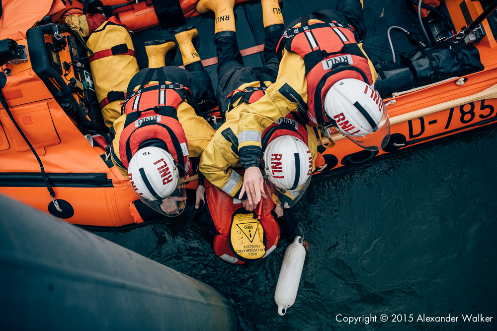 Matt Allchurch, Mark Gibson and Jon Chapman, Volunteer Crew at Teddington Lifeboat Station RNLI onboard the station's Class D Lifeboat on a training exercise practiing man overboard drills