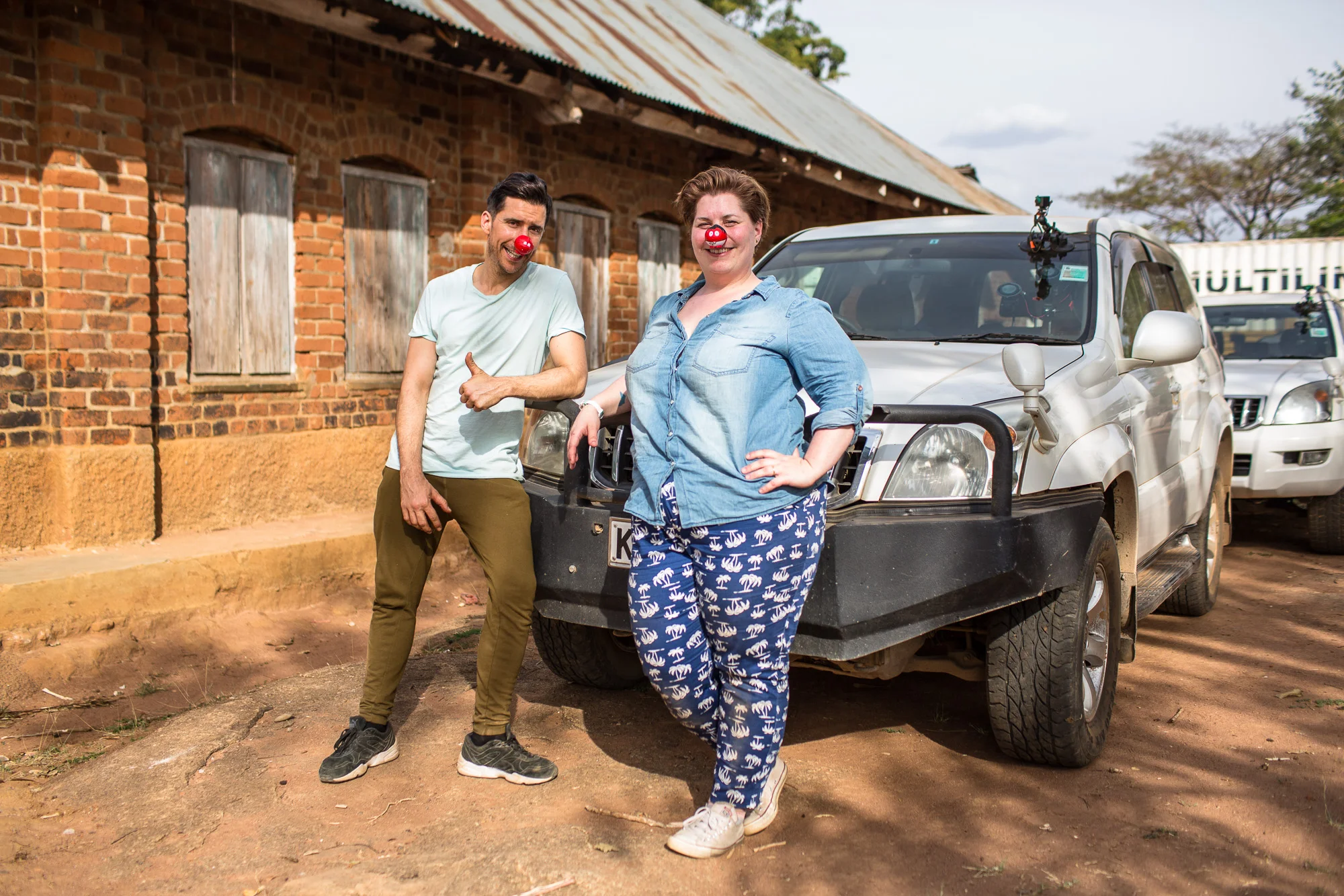 Russell Kane and Katy Brand, Red Nose Convoy drivers next to their vehicle.