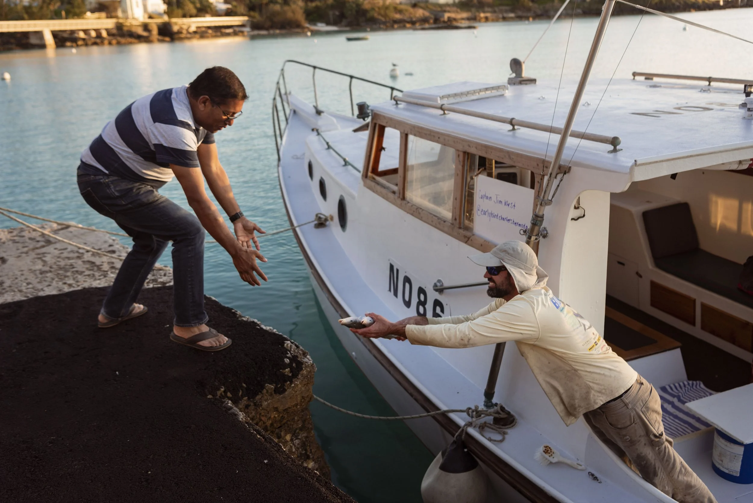  Capt. Jim West of Early Bird Charters sells his day’s catch to a local chef for a dinner organized by Das Fete for Condé Nast on March 27, 2020 at Bailey’s Bay Dock in Bermuda. 