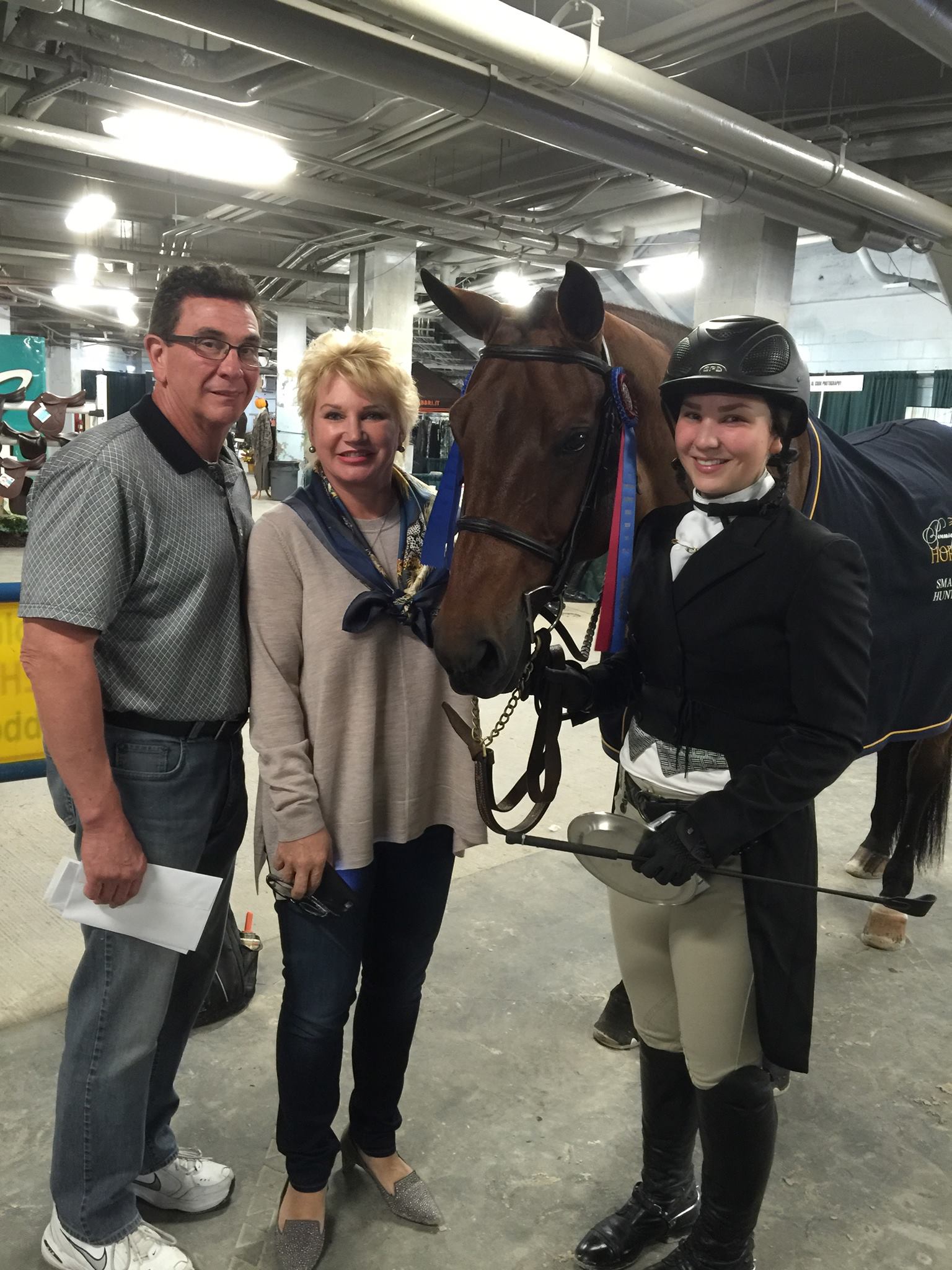 Alex Trolli and her parents Joe and Michele celebrating Hey Sailor's championship,