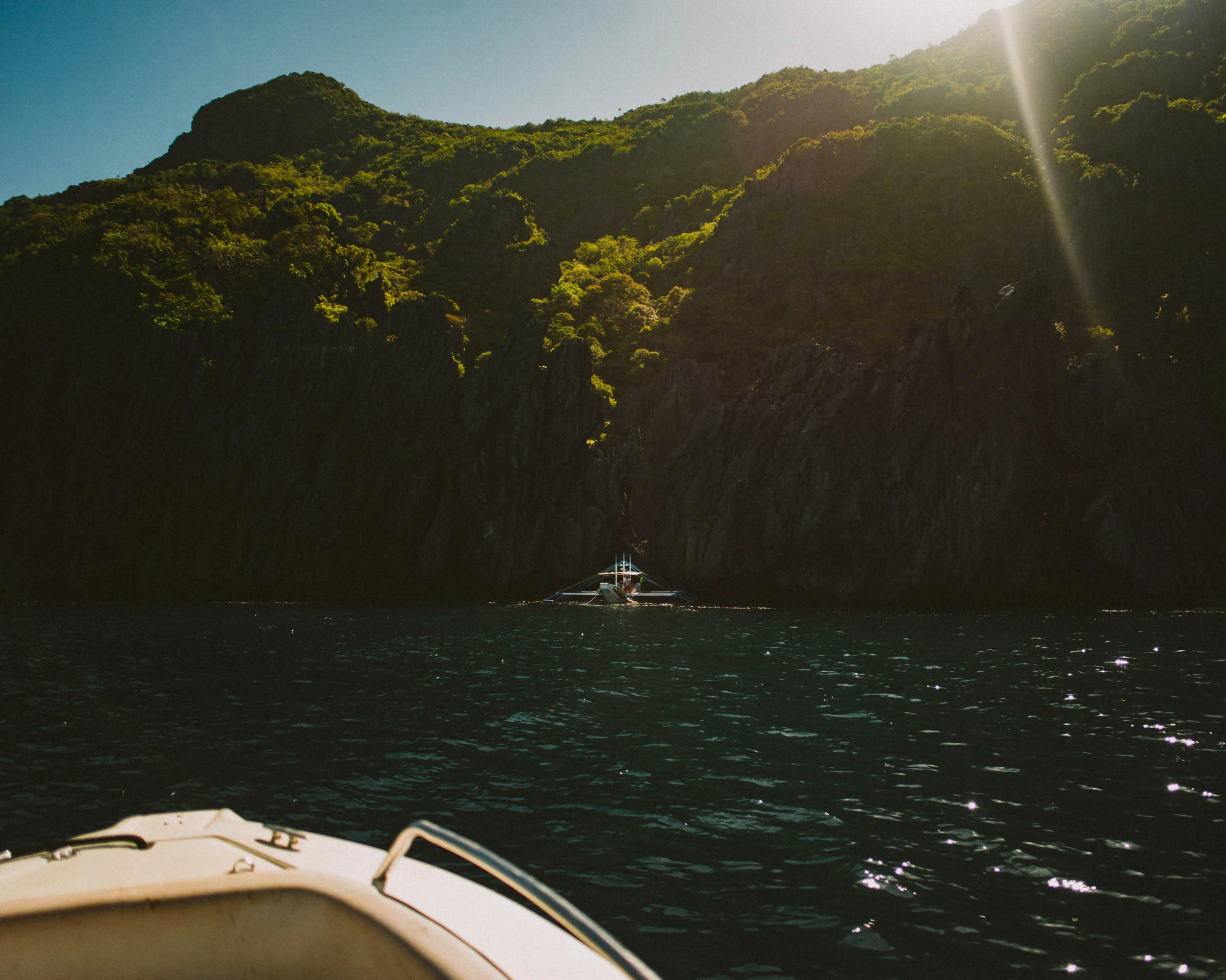 Secret Beach's entrance is through a crevice (behind that outrigger boat). You would have to swim to get inside.