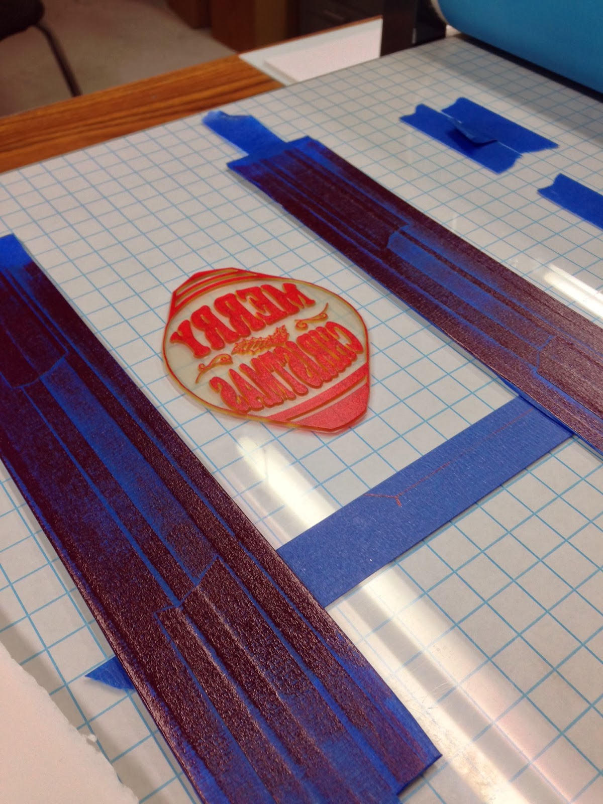 Inking up the ornament plate using some rails so ink doesn't get all over the press bed. 