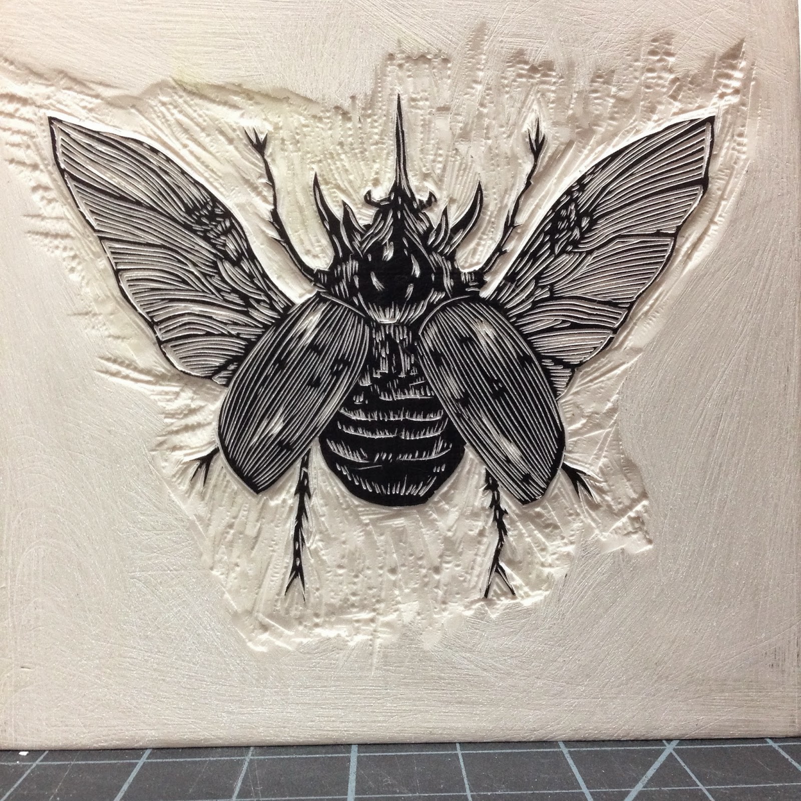 The "Rhinoceros Beetle" block before carving away all of the area around the insect.