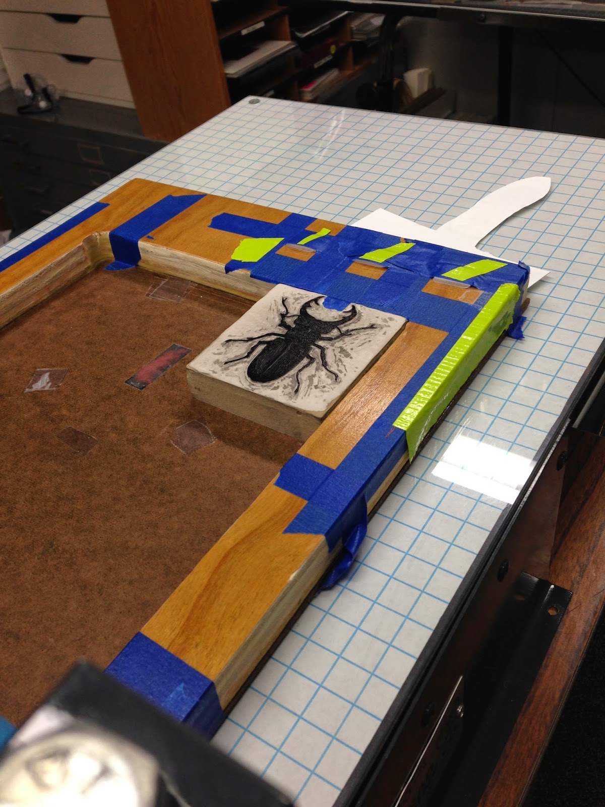Inked beetle on press.