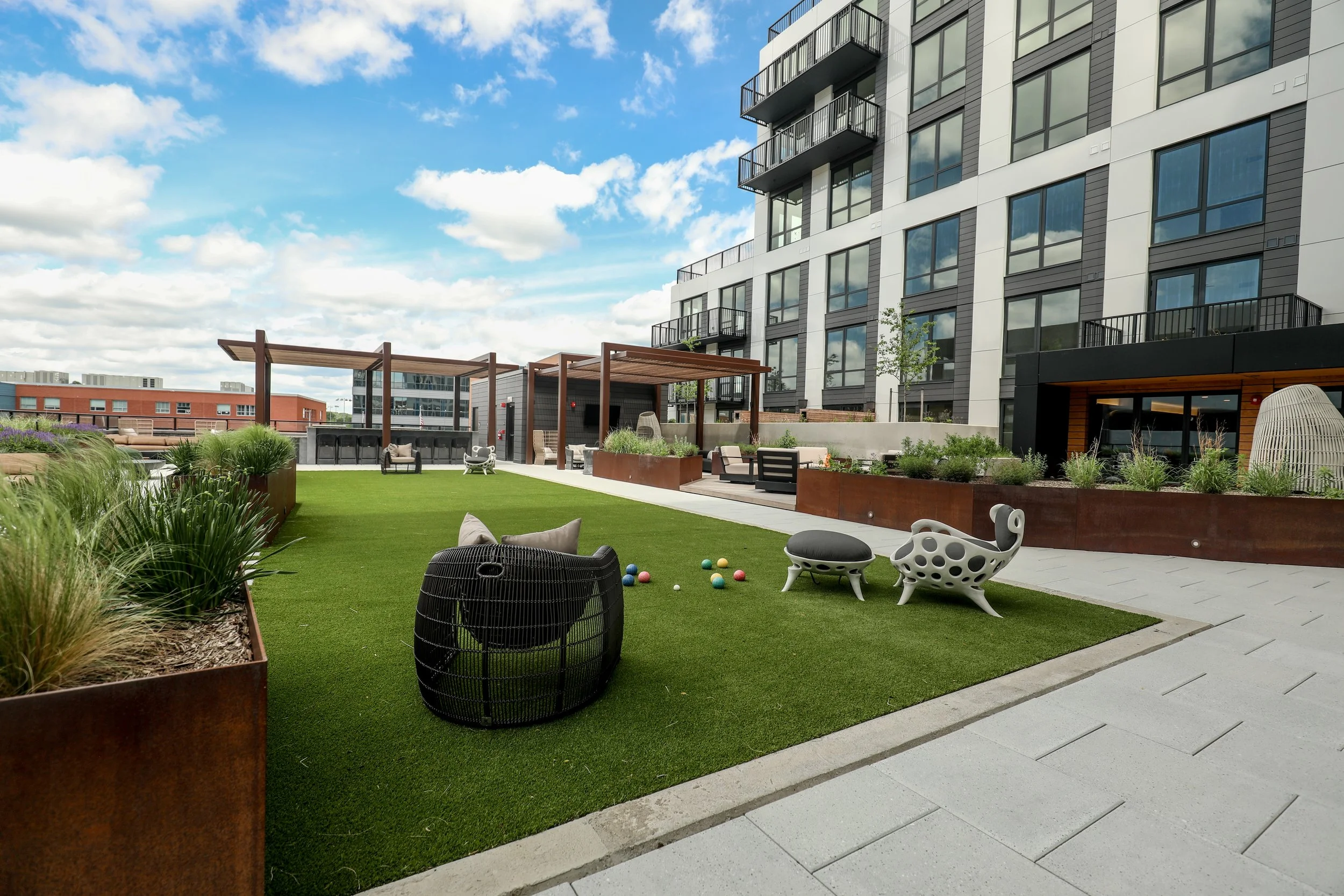 Commercial architectural photography featuring outdoor gathering spaces and resident amenities.