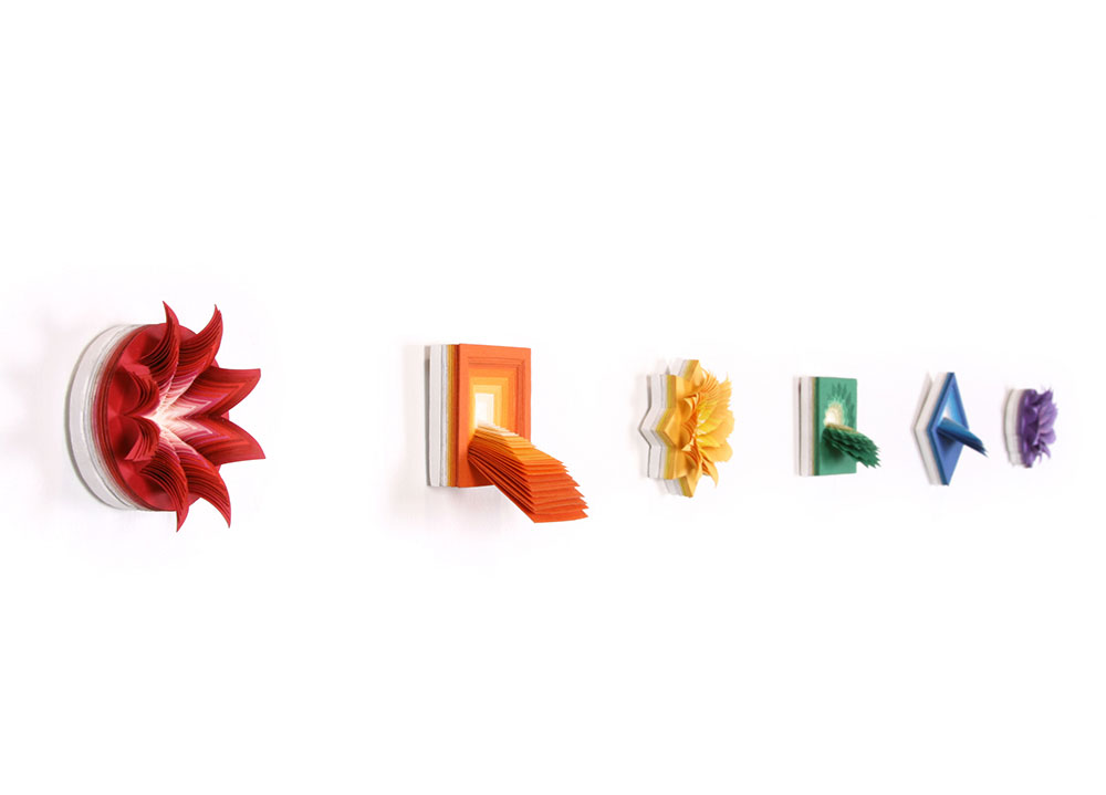  Micros (Purple, Red, Orange, Yellow, Green, Blue), 2012, hand-cut acid-free paper, glue, wood, 2 x 2 x 1 in each (6 total) 