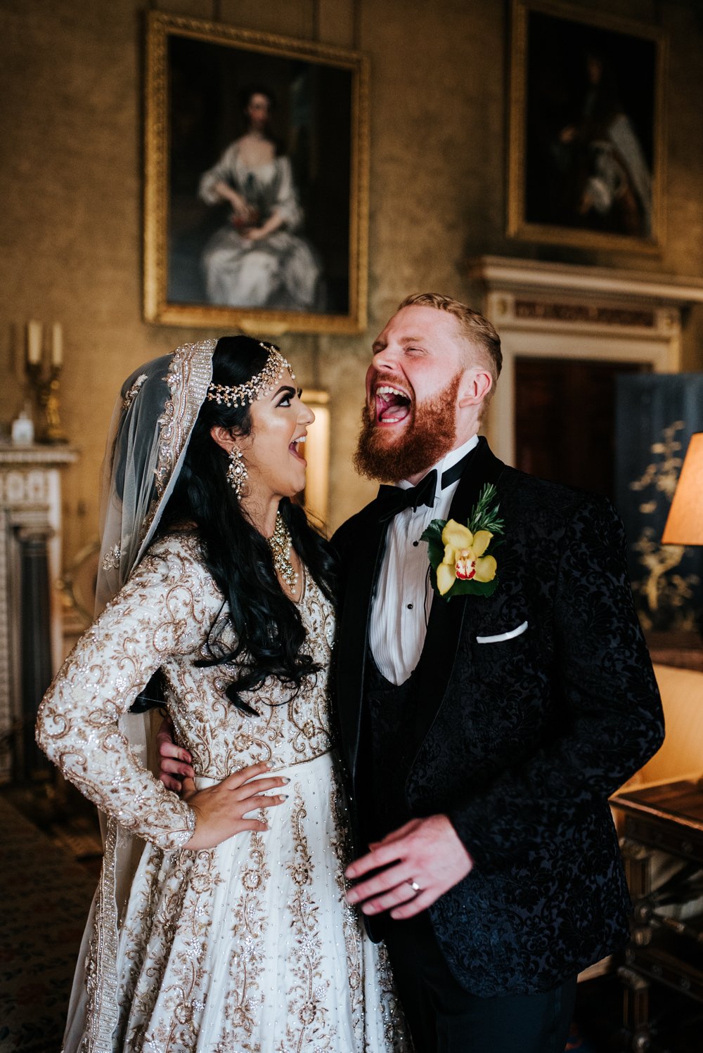 Bride and groom pose for photograph in one of the drawing rooms at Syon Park wedding