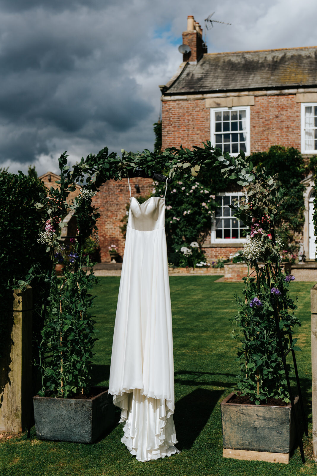 Bride's dress hanging by house