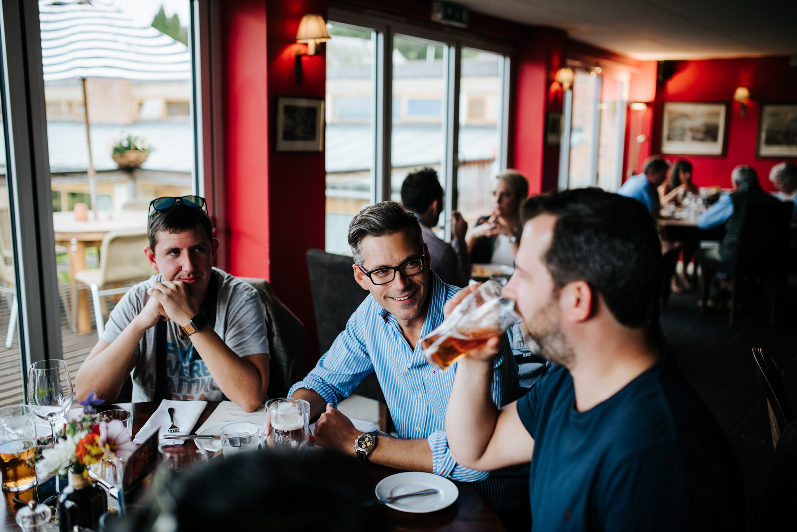 Groom sits with groomsmen at lunch