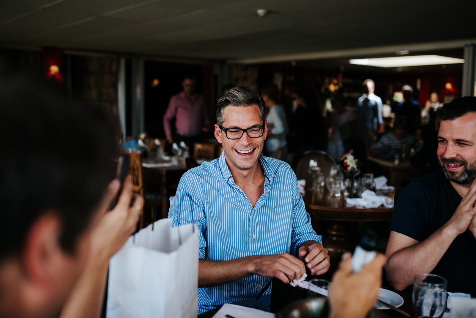 Groom opens present from bride during preparations