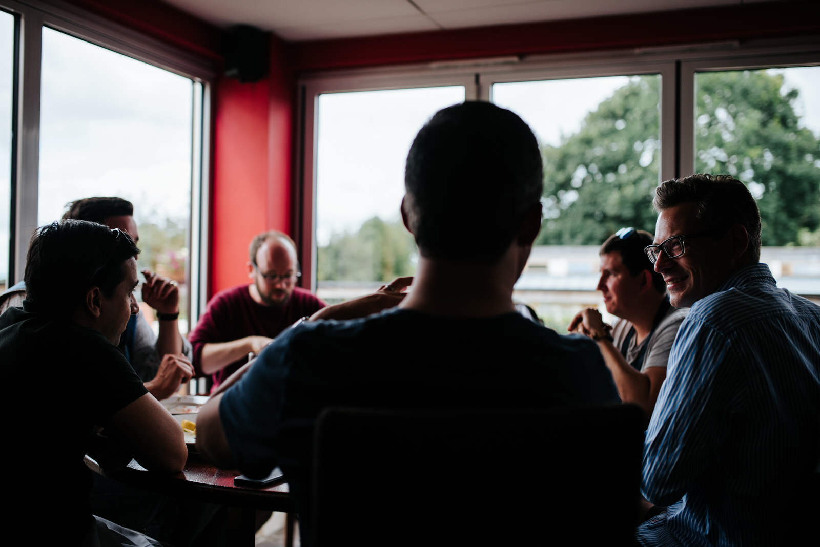 Groom looks at groomsmen in pub in Yorkshire