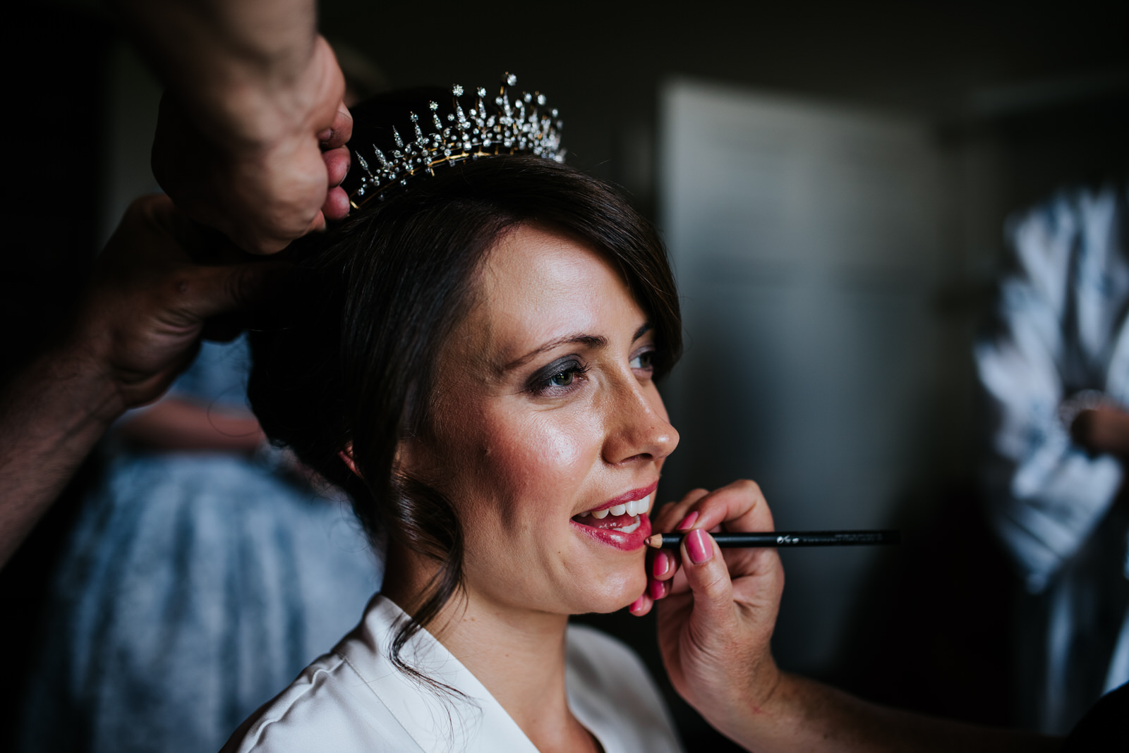 Bride looking glamorous as makeup is applied to her lips