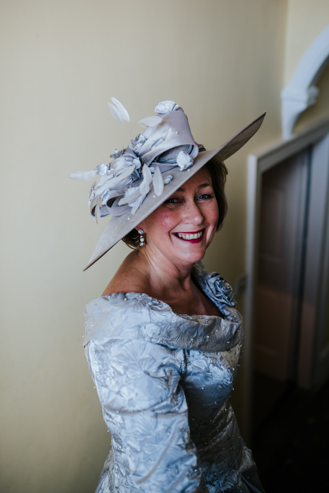 Mother of the bride looks fantastic with regal hat 