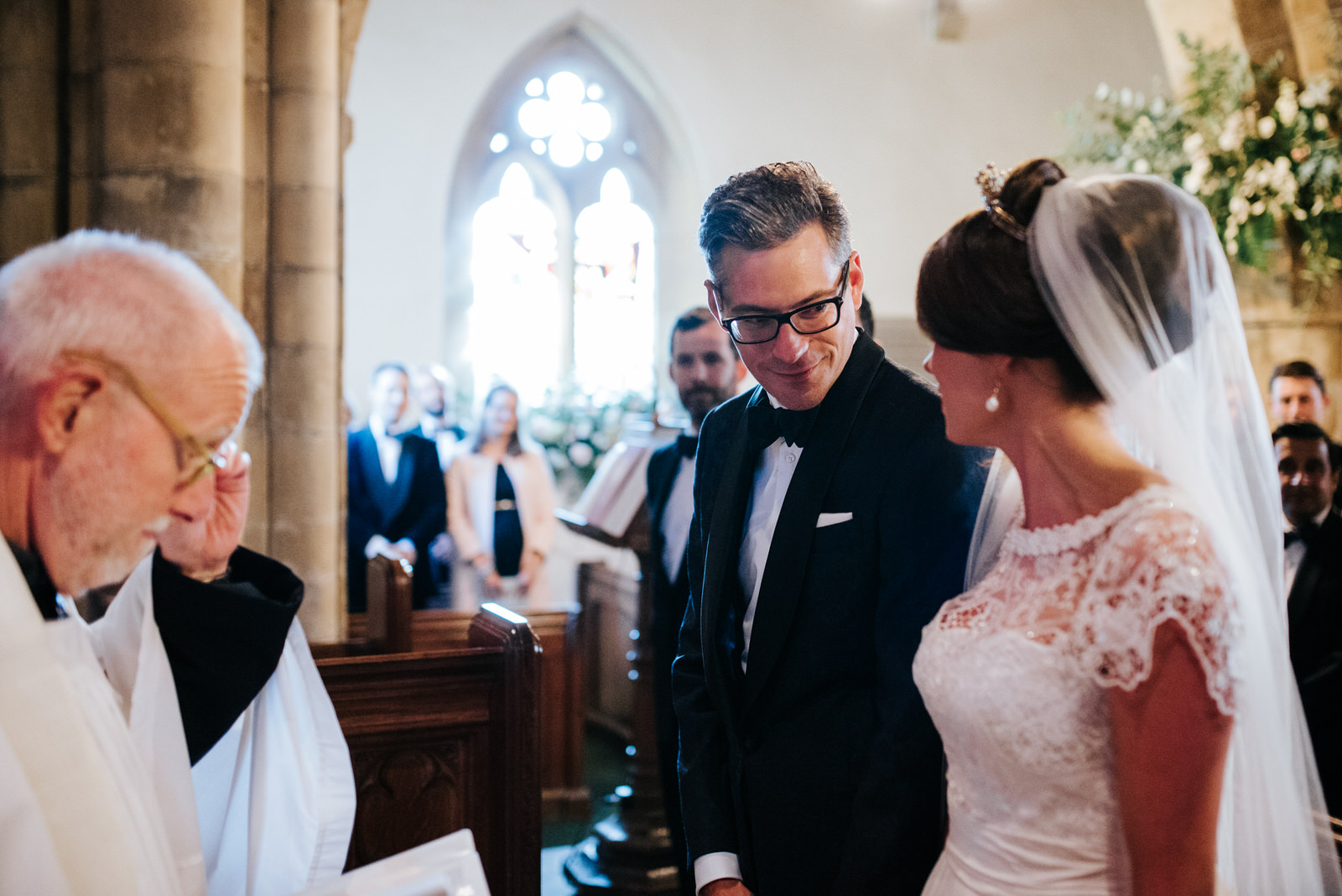 Grooms sees Bride inside Church for the first time and smiles