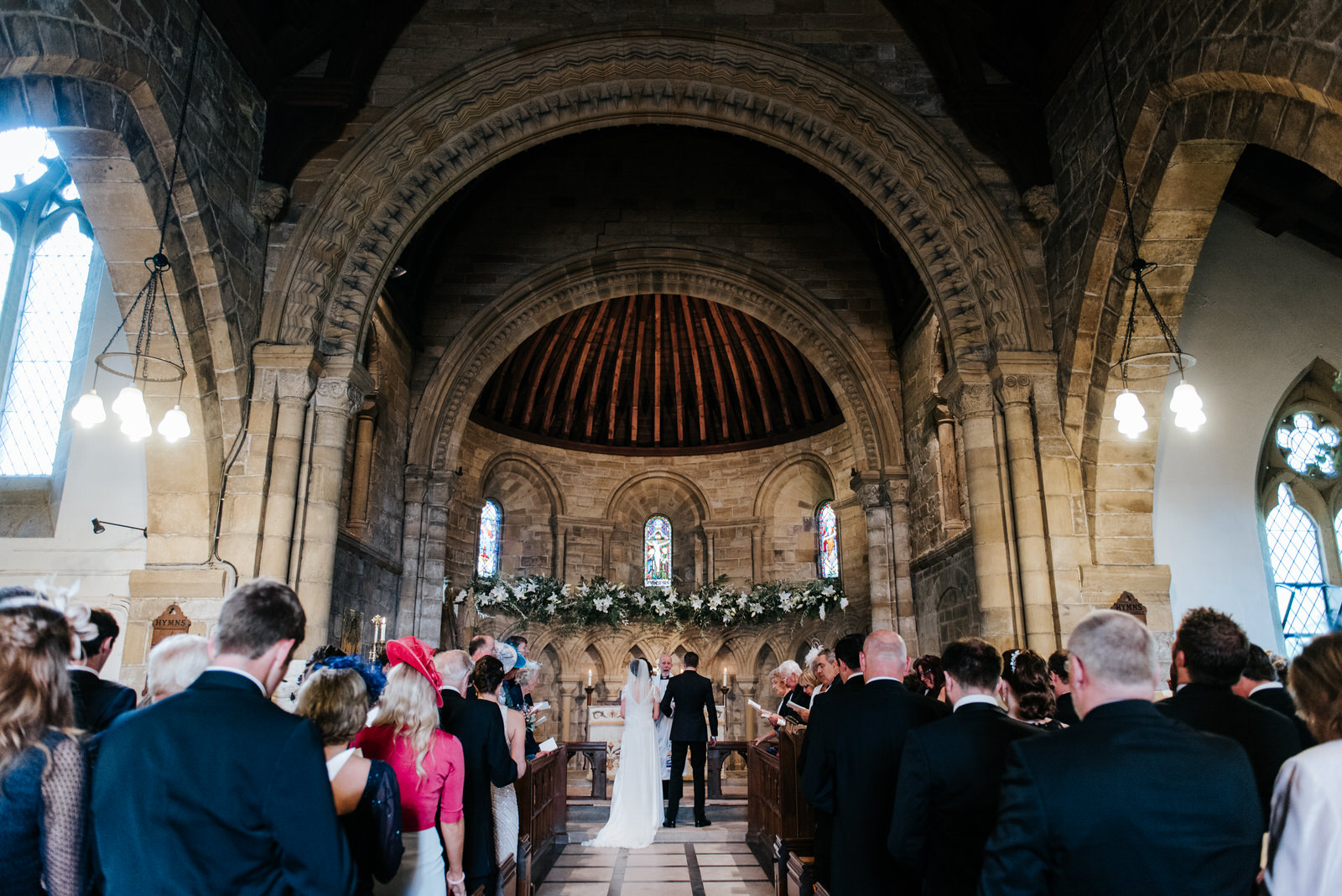 Wide shot of Felixkirk Church interior with Bride and Groom at t