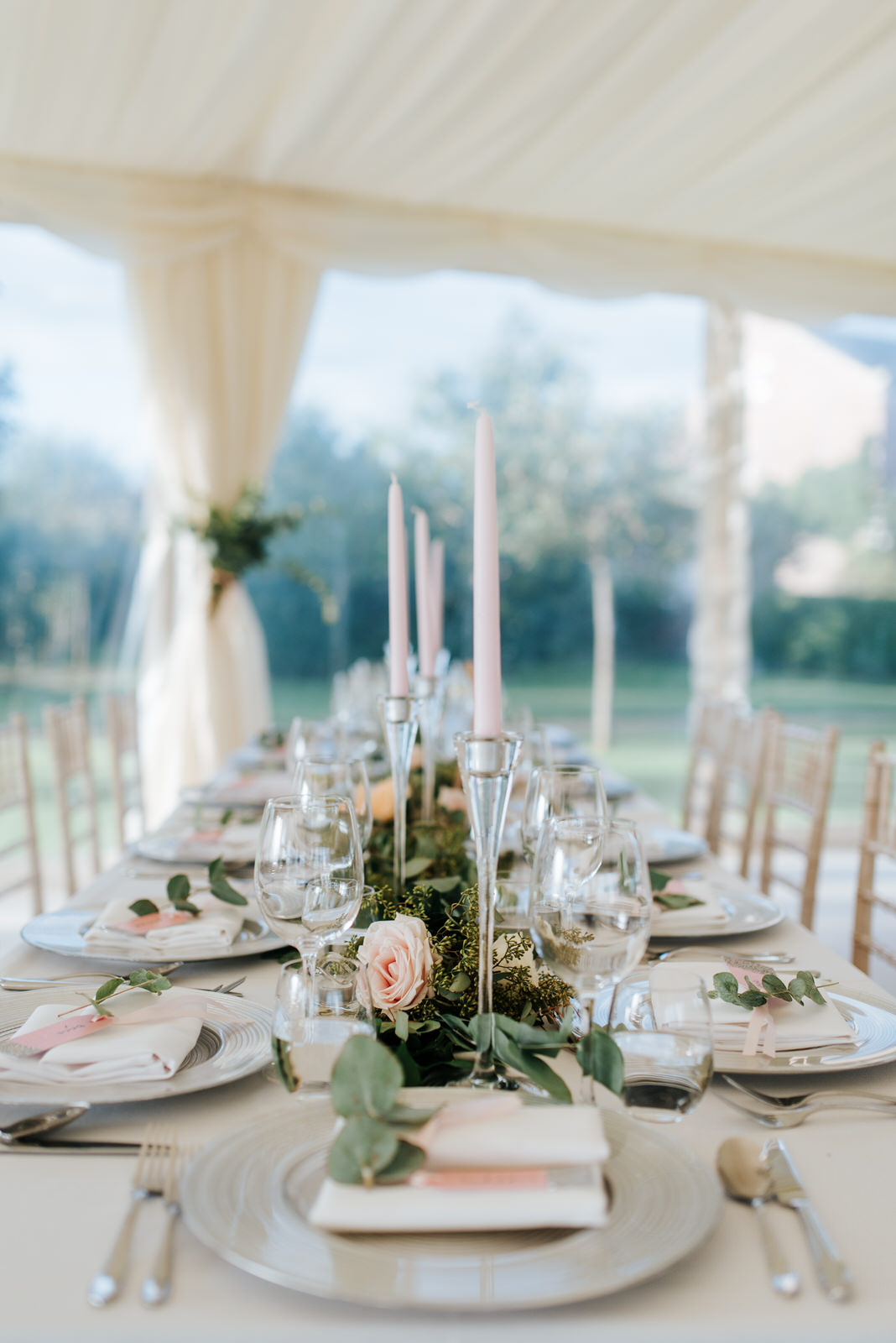 Close-up of table setting inside stunning, tree-lined garden mar