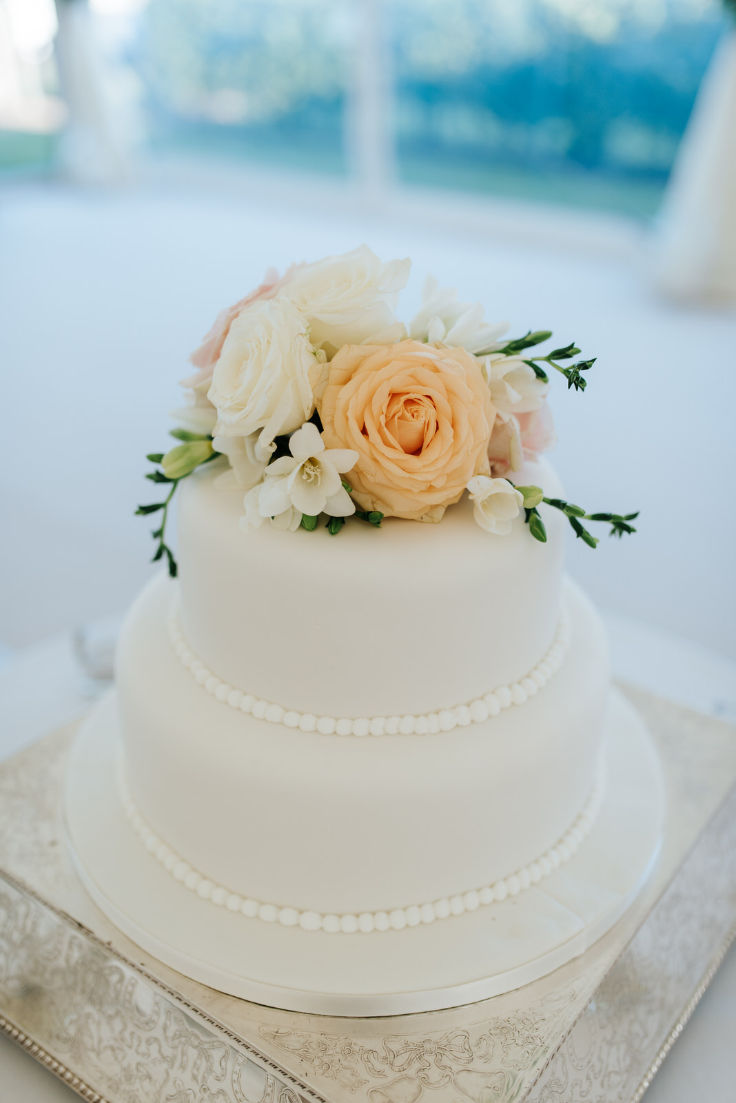 Photo of wedding cake with flowers by Twinkling Twine