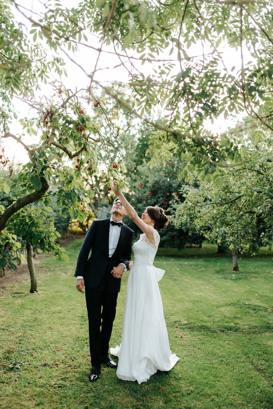 Bride and Groom standing under Plum tree in Yorkshire