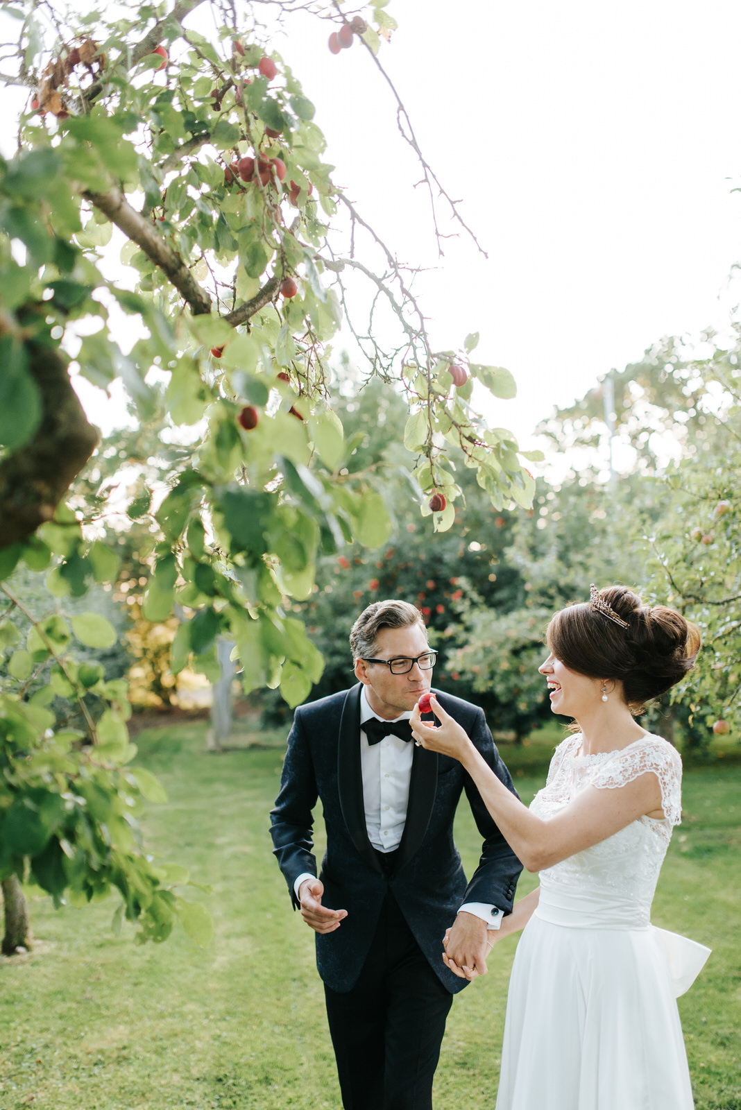 Bride gives plum to Groom so he can take a bite out of it during