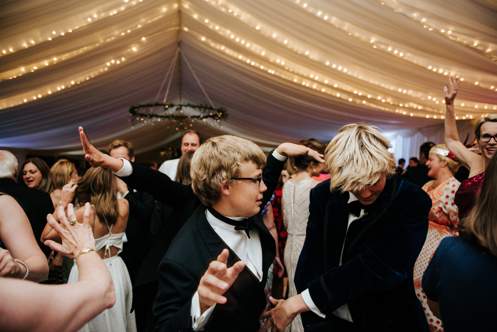 Guests flood the dancefloor under marquee fairylights