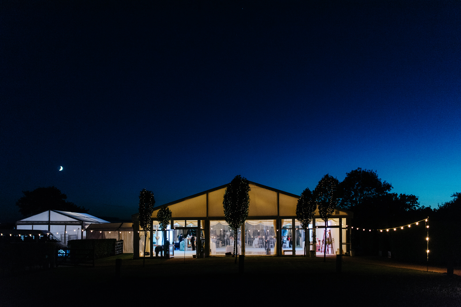 Exterior photo of wedding marquee in Yorkshire as moon rises and