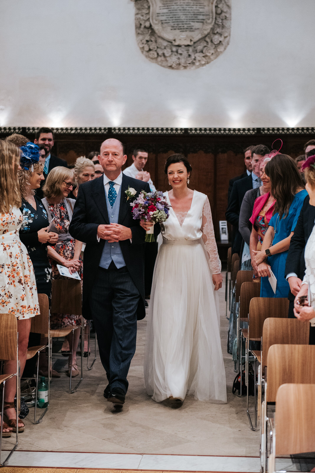 Bride and father of the bride walk down the aisle at Jesus Colle