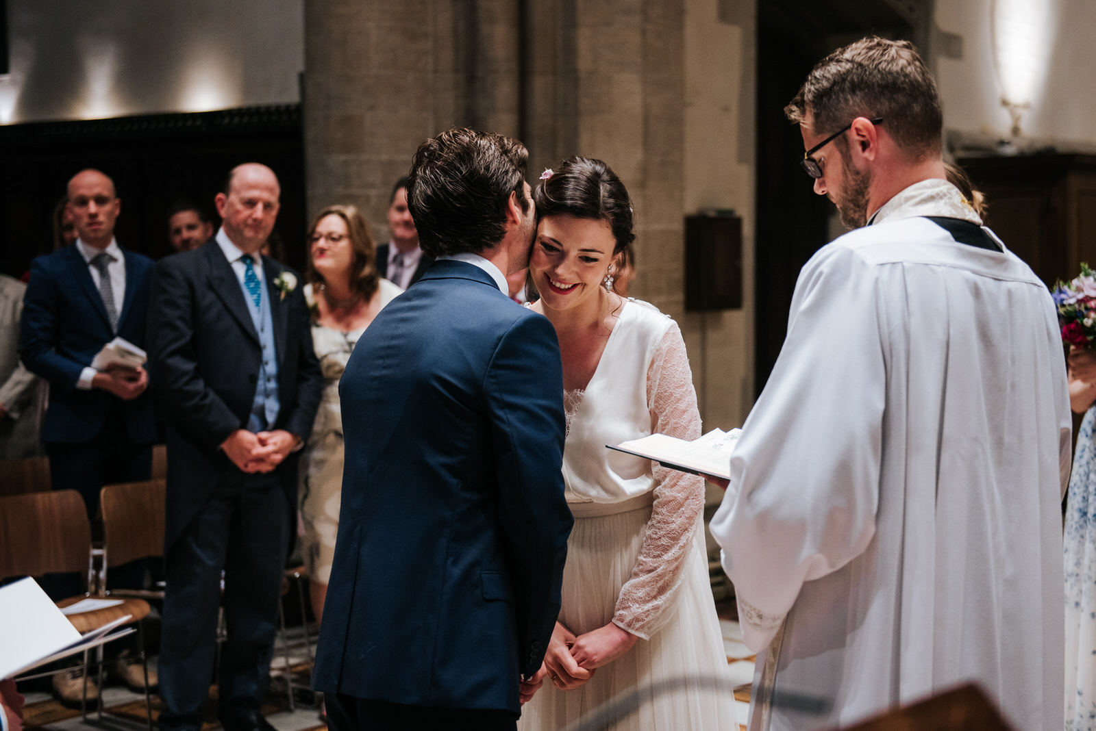 Groom embraces his Bride at the altar in Jesus College Chapel, C